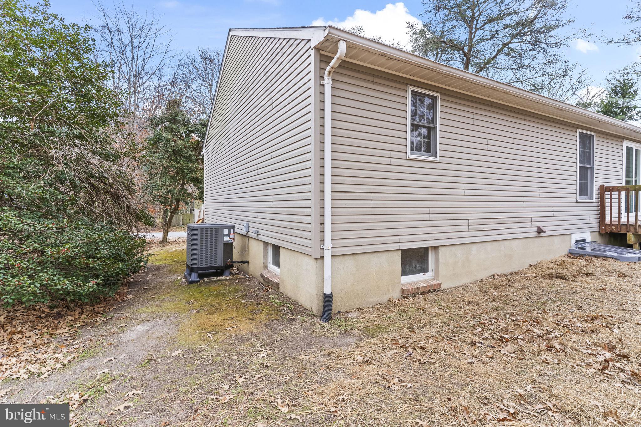 11223 Rawhide Road Lusby, MD 20657 - Photo 31 of 33 a view of a house with a yard and garage