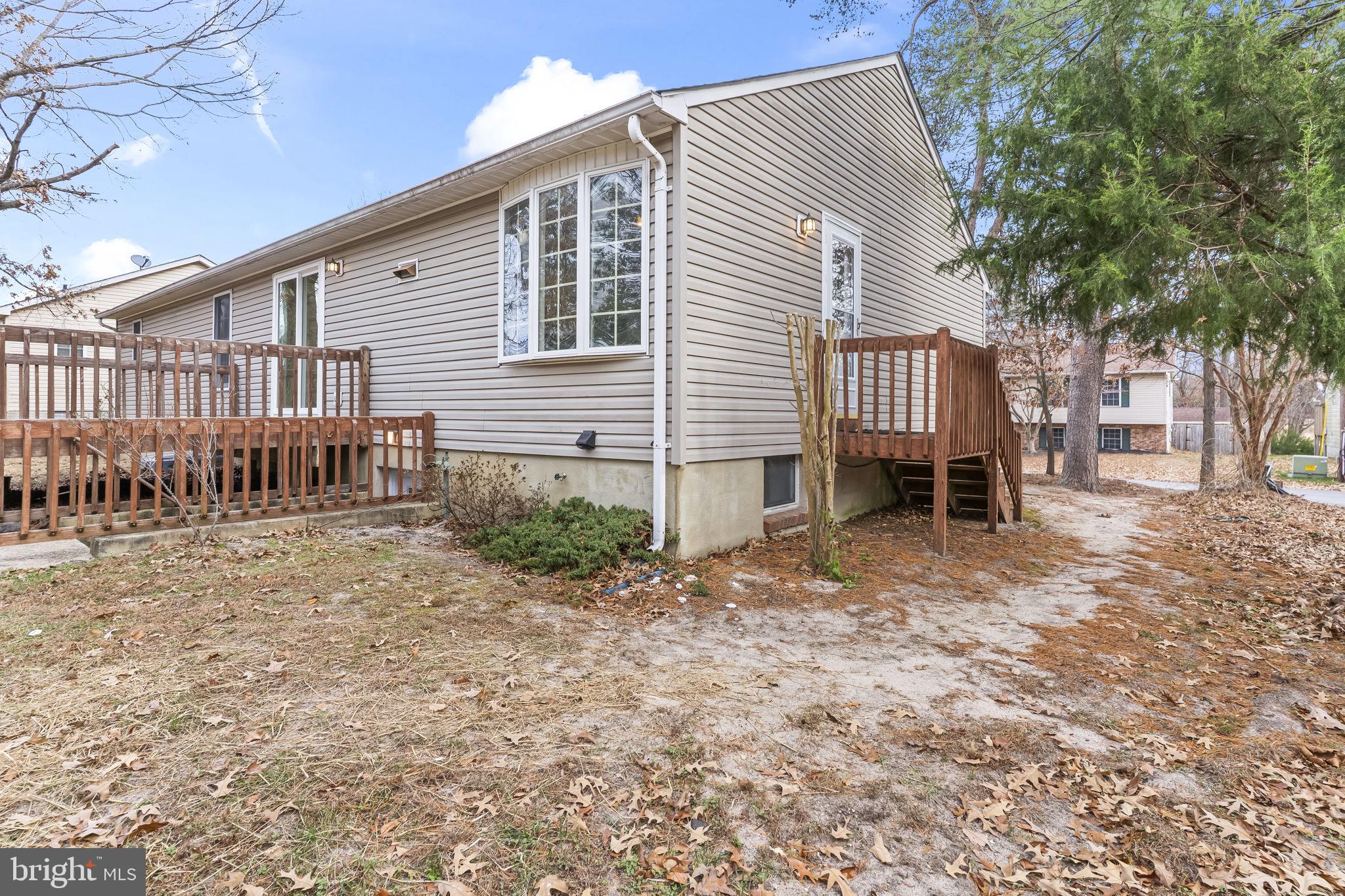 11223 Rawhide Road Lusby, MD 20657 - Photo 32 of 33 a backyard of a house with barbeque oven table and chairs
