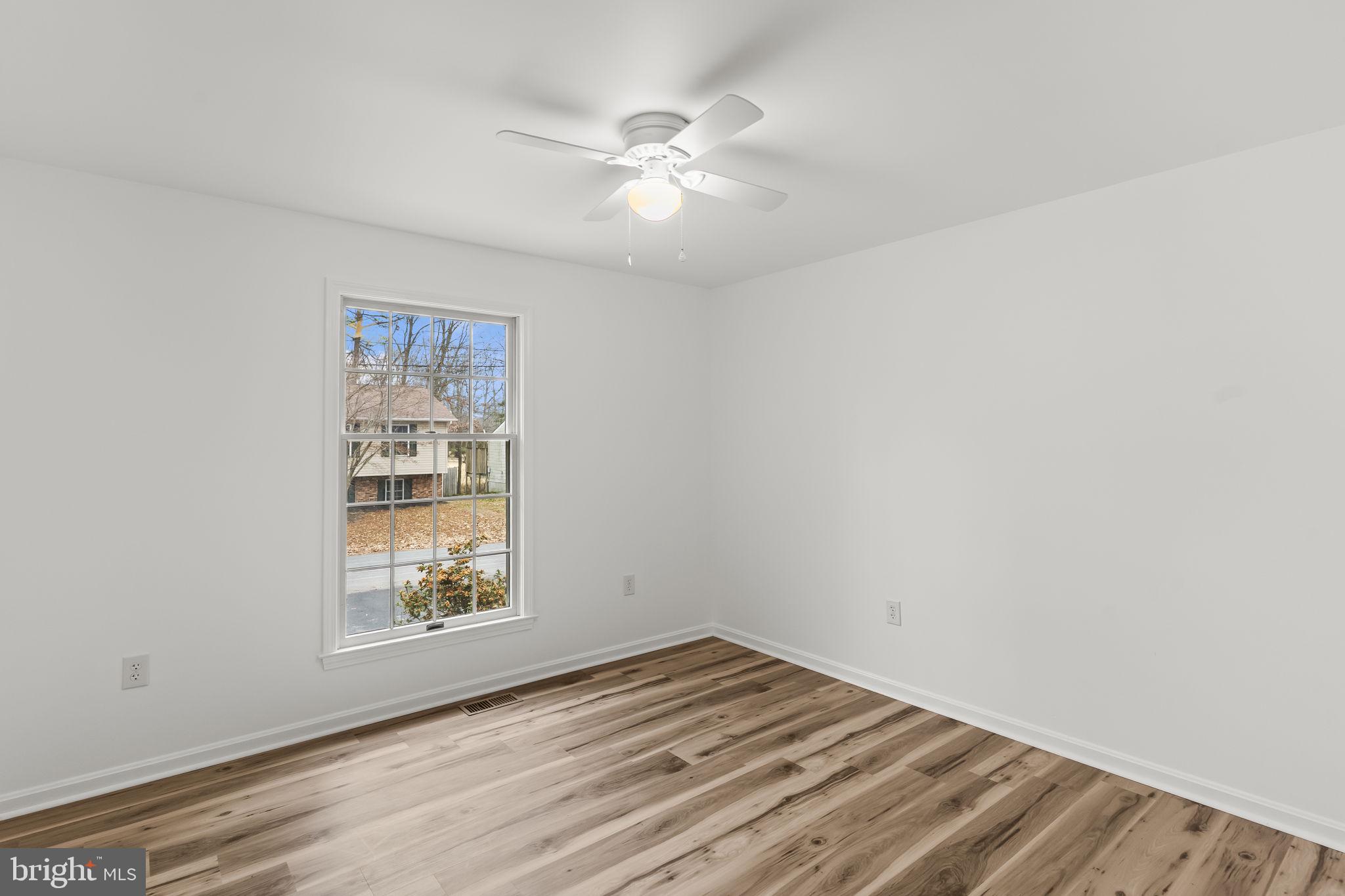 11223 Rawhide Road Lusby, MD 20657 - Photo 10 of 33 an empty room with windows and fan
