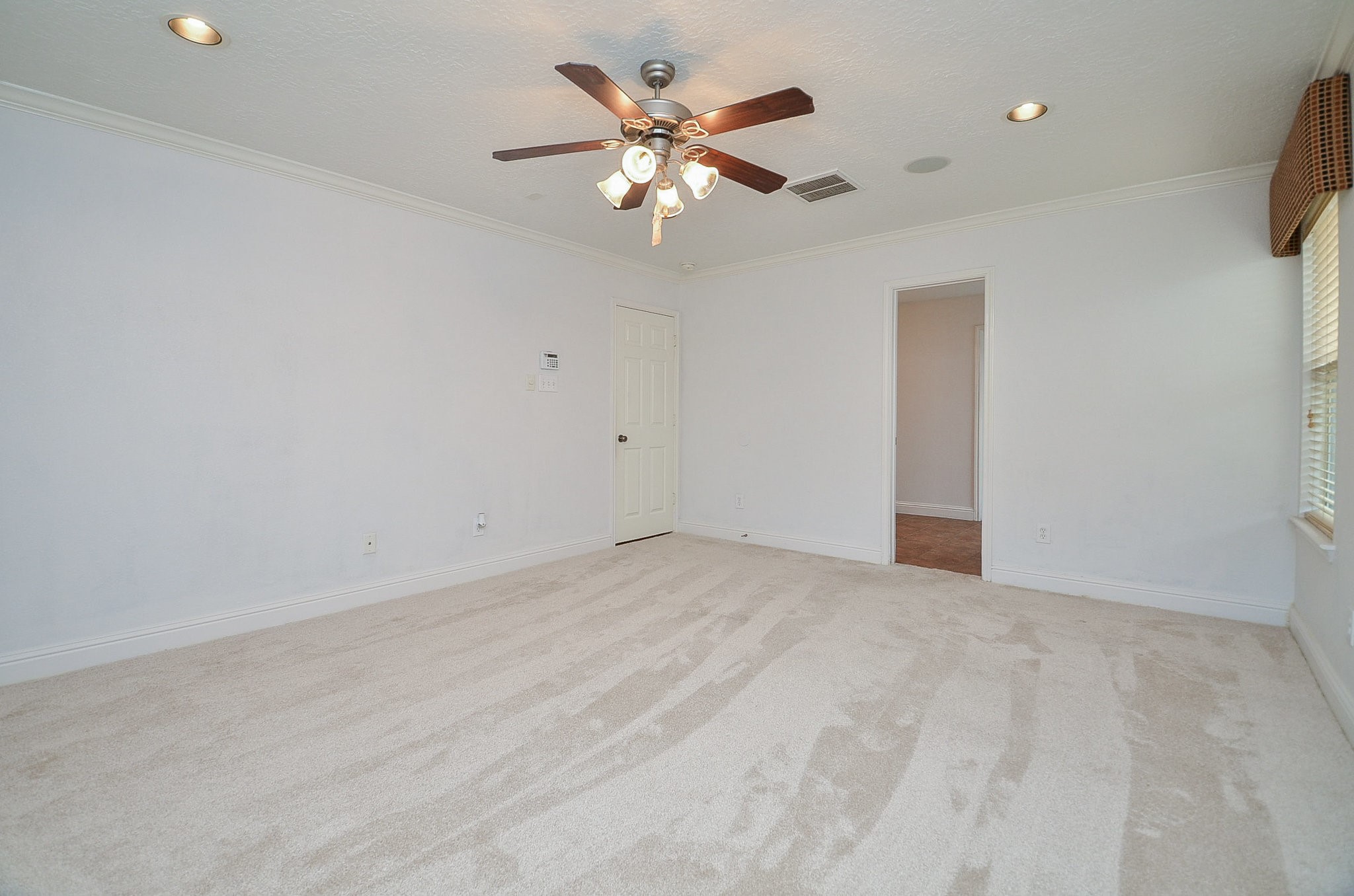 29610 Benson Springs Lane Spring, TX 77386 - Photo 14 of 25 an empty room with chandelier fan and windows