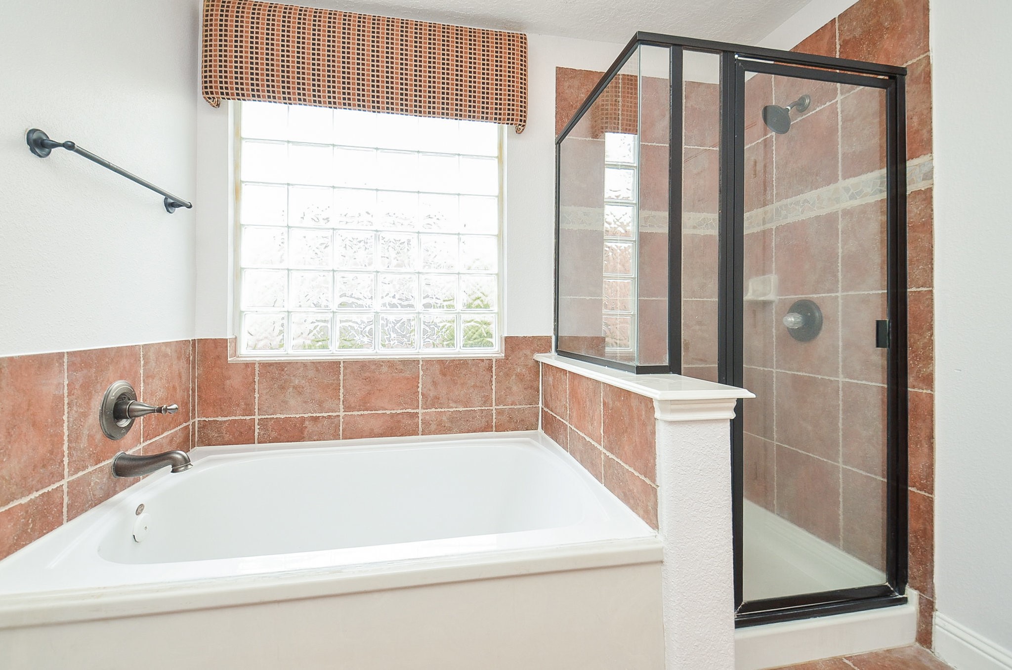 29610 Benson Springs Lane Spring, TX 77386 - Photo 16 of 25 a bathroom with a bathtub and a shower
