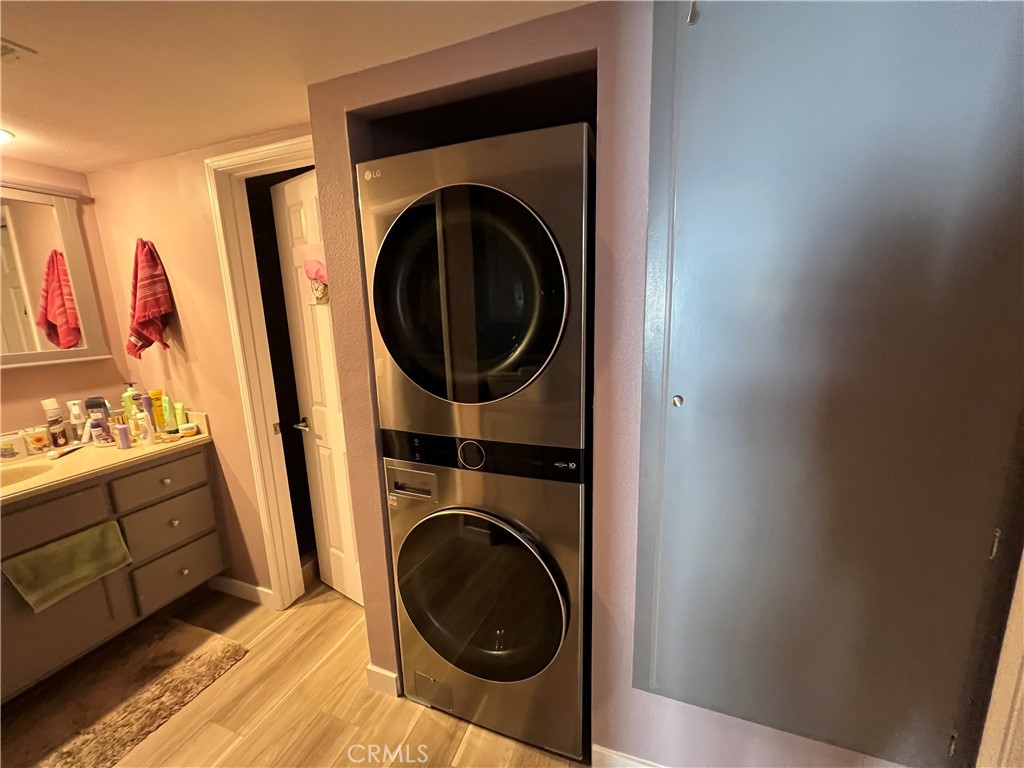 1111 Packers Circle, Unit 25 Tustin, CA 92780 - Photo 7 of 10 a view of a hallway with washer and dryer