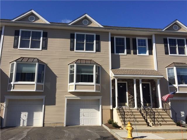 15 Scuppo Road, Unit 504 Danbury, CT 06811 - Photo 1 of 1 a front view of a house with a yard