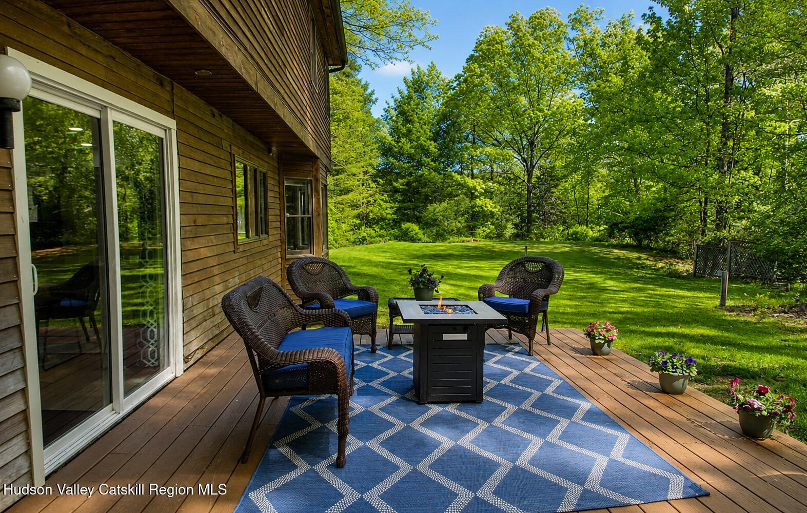 25 Old Farm Road Shokan, NY 12481 - Photo 22 of 22 a view of a patio with table and chairs potted plants with wooden floor and fence