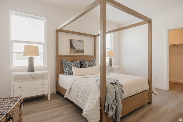 4595 North Fallow Way, Unit 511 Eagle Mountain, UT 84005 - Photo 23 of 32 Bedroom with a spacious closet and light wood finished floors
