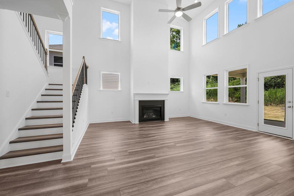 8925 Avonbrook Cl Ball Ground, GA 30107 - Photo 13 of 48 a view of a livingroom with wooden floor and a fireplace