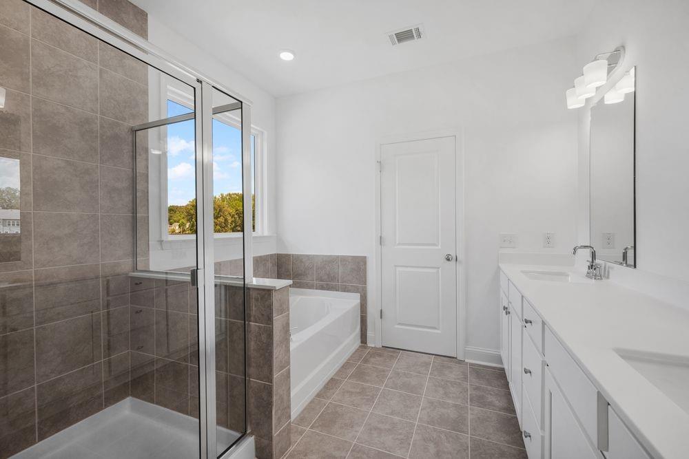 8925 Avonbrook Cl Ball Ground, GA 30107 - Photo 17 of 48 a bathroom with a double vanity sink and mirror