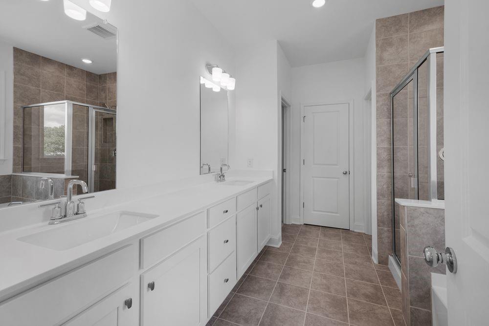 8925 Avonbrook Cl Ball Ground, GA 30107 - Photo 18 of 48 a spacious bathroom with double sink and a mirror