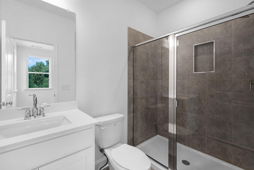 8925 Avonbrook Cl Ball Ground, GA 30107 - Photo 29 of 48 a bathroom with a sink toilet and shower