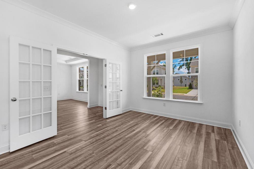 8925 Avonbrook Cl Ball Ground, GA 30107 - Photo 5 of 48 a view of an empty room with wooden floor and a window