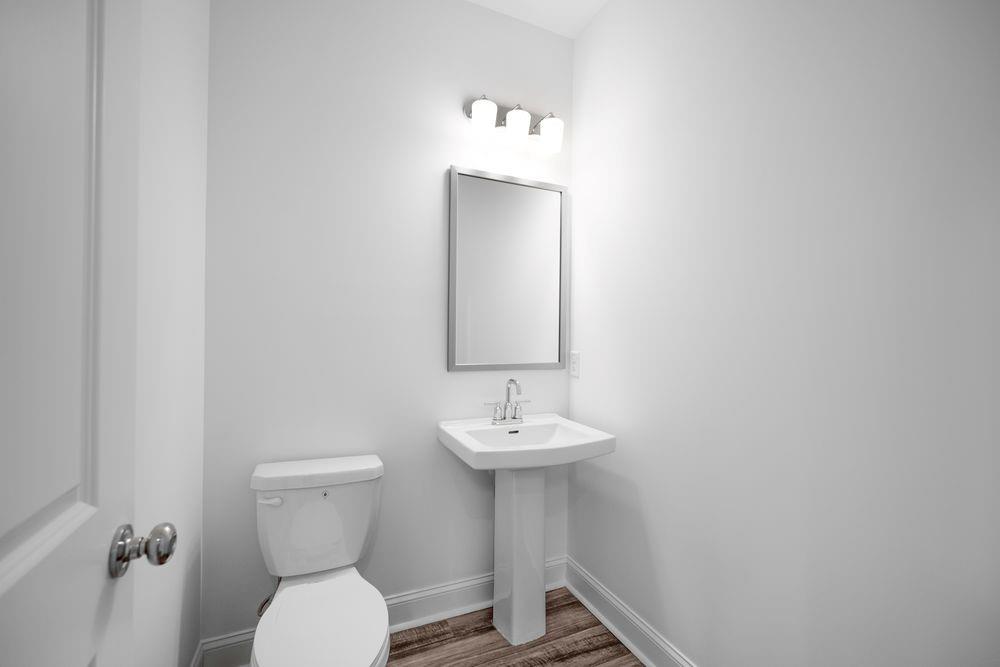 8925 Avonbrook Cl Ball Ground, GA 30107 - Photo 7 of 48 a bathroom with a toilet sink and mirror