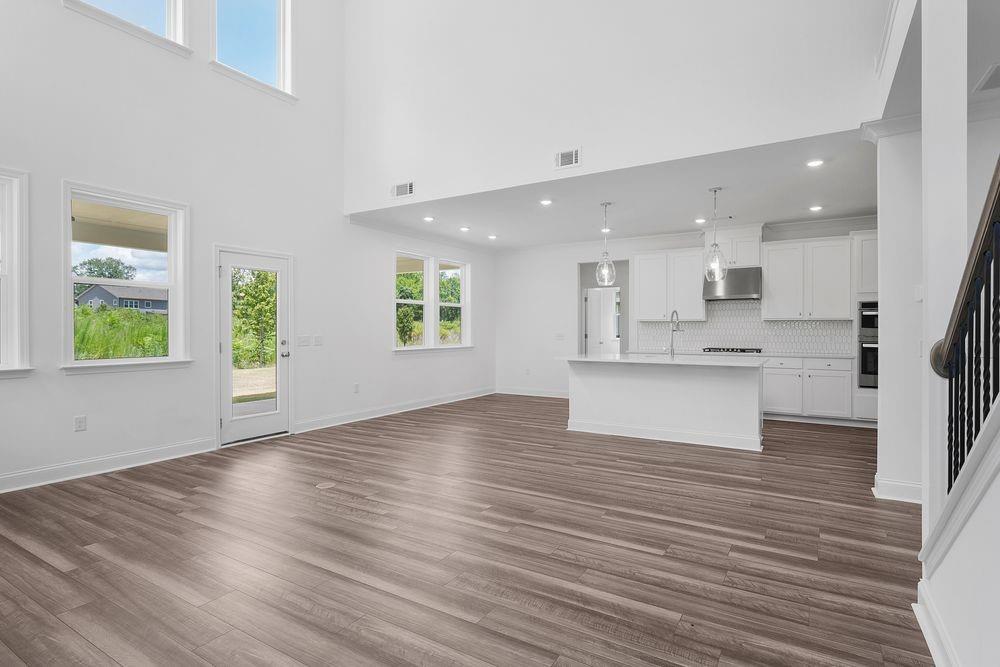 8925 Avonbrook Cl Ball Ground, GA 30107 - Photo 10 of 48 a view of kitchen with wooden floor and windows