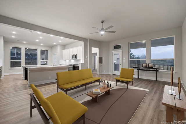 a kitchen with kitchen island stainless steel appliances a stove sink microwave and cabinets