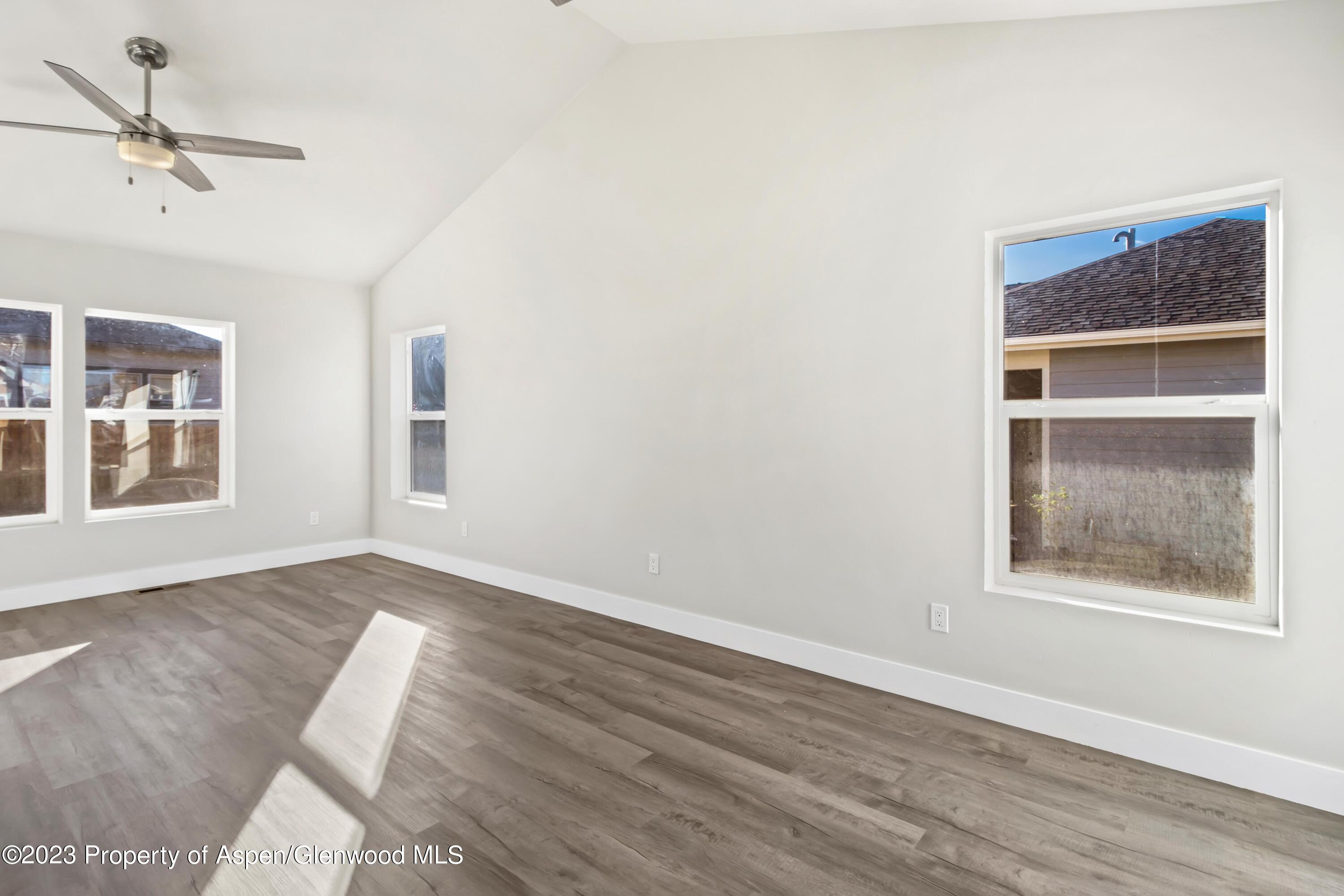 1762 Belgian Loop Silt, CO 81652 - Photo 7 of 18 a view of an empty room with a window and wooden floor