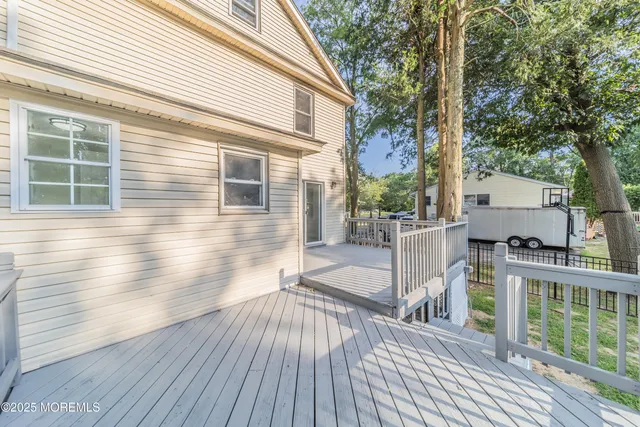 a view of a deck with wooden floor and fence with a wooden fence