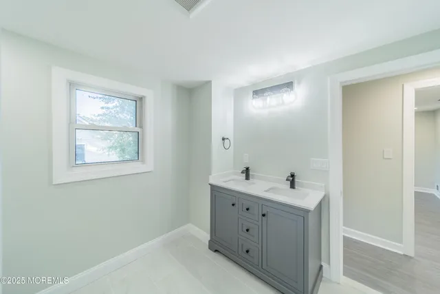 a bathroom with 2 sink tub and a mirror