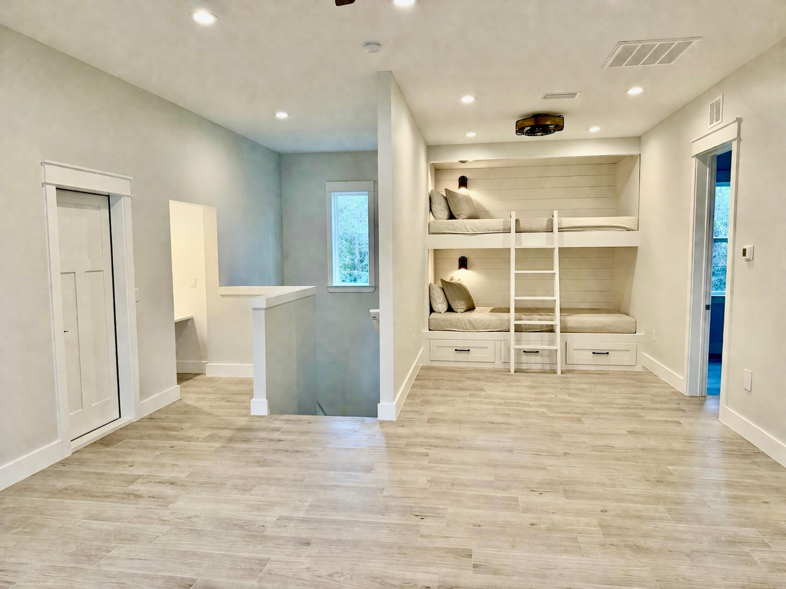 116 East Georgie Street Point Washington, FL 32459 - Photo 11 of 46 a view of a kitchen with wooden floor and a ceiling fan