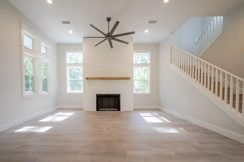 a view of empty room with fireplace and fan