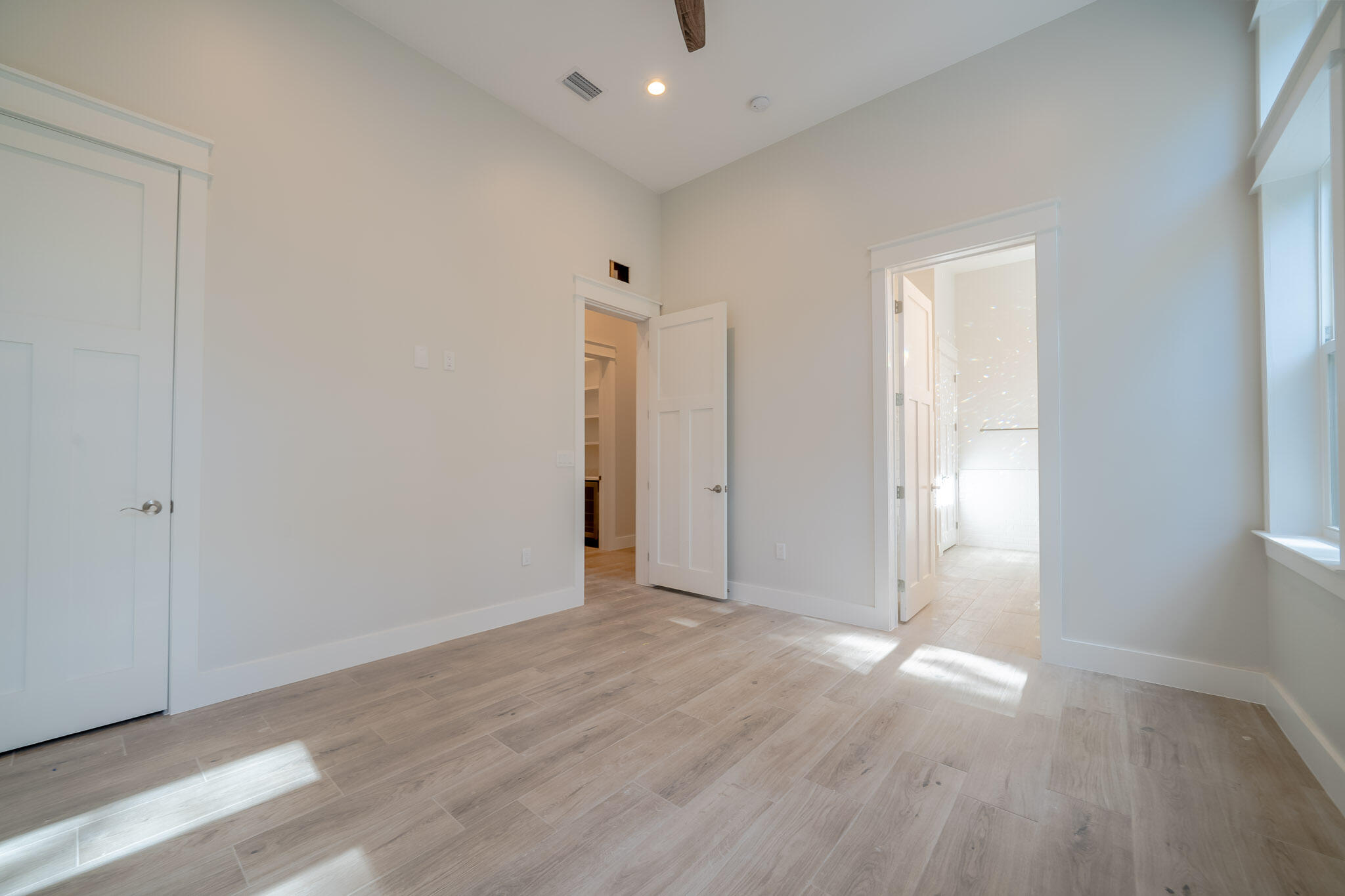 116 East Georgie Street Point Washington, FL 32459 - Photo 20 of 46 an empty room with wooden floor and windows