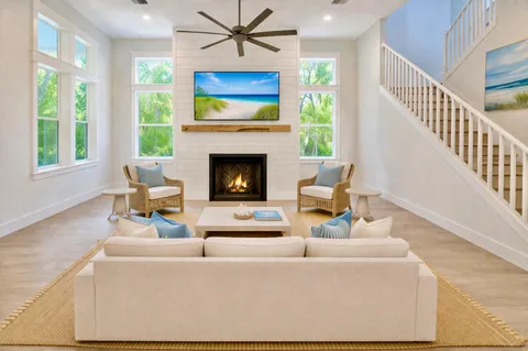 a living room with furniture a fireplace and a flat screen tv