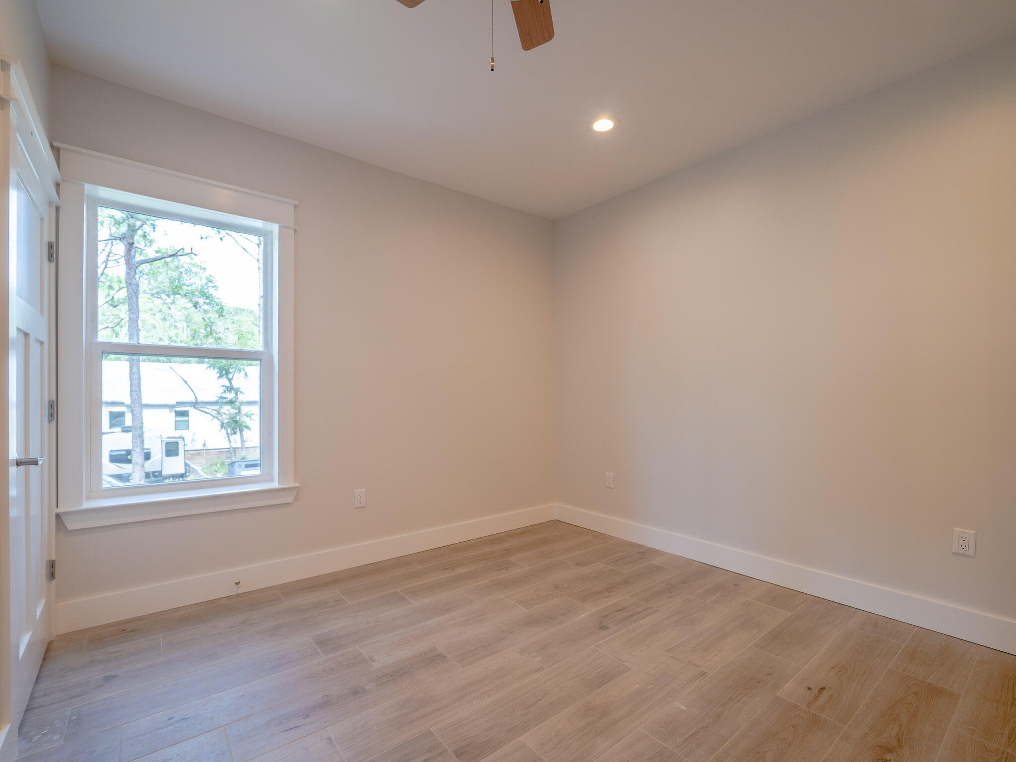 116 East Georgie Street Point Washington, FL 32459 - Photo 21 of 46 an empty room with wooden floor and windows