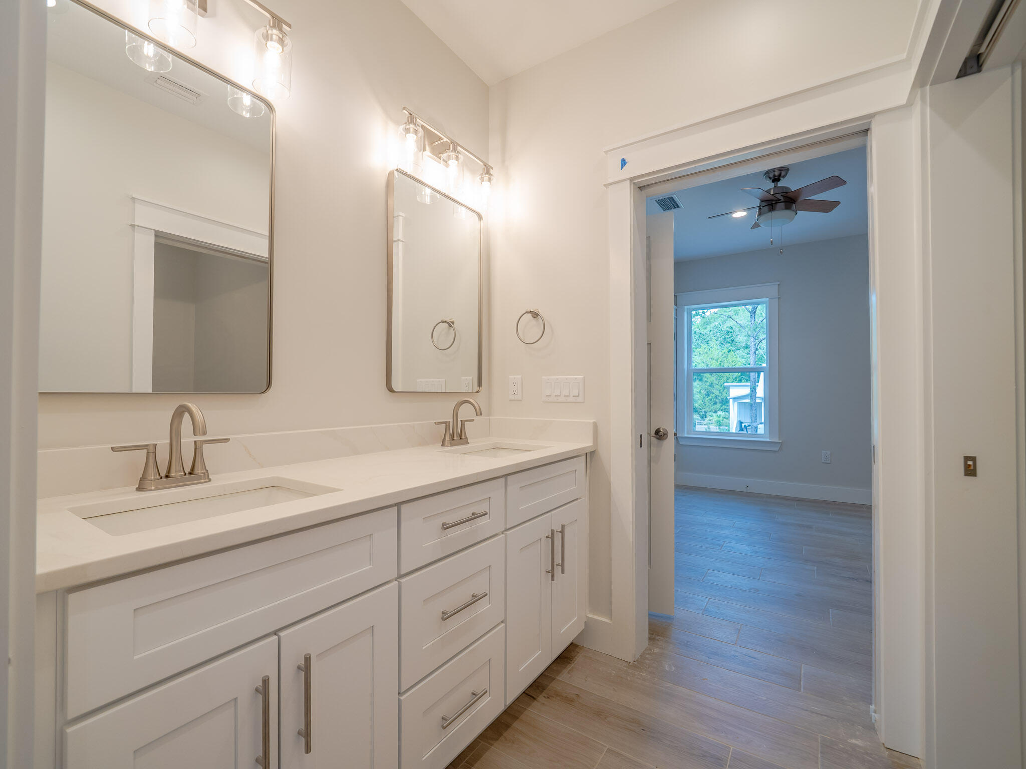 116 East Georgie Street Point Washington, FL 32459 - Photo 22 of 46 a bathroom with a double vanity sink and mirror with shower