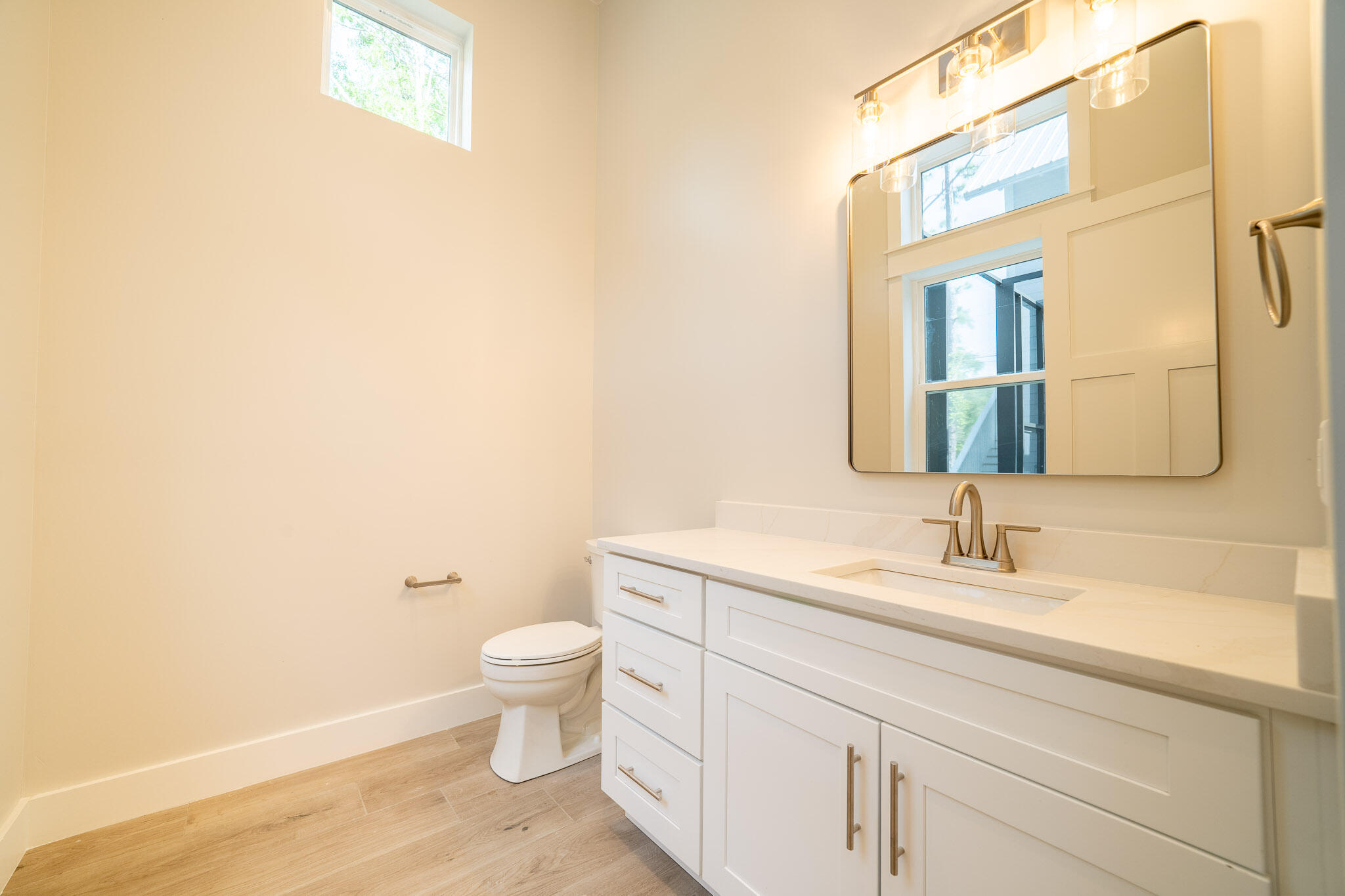 116 East Georgie Street Point Washington, FL 32459 - Photo 24 of 46 a bathroom with a toilet sink and mirror