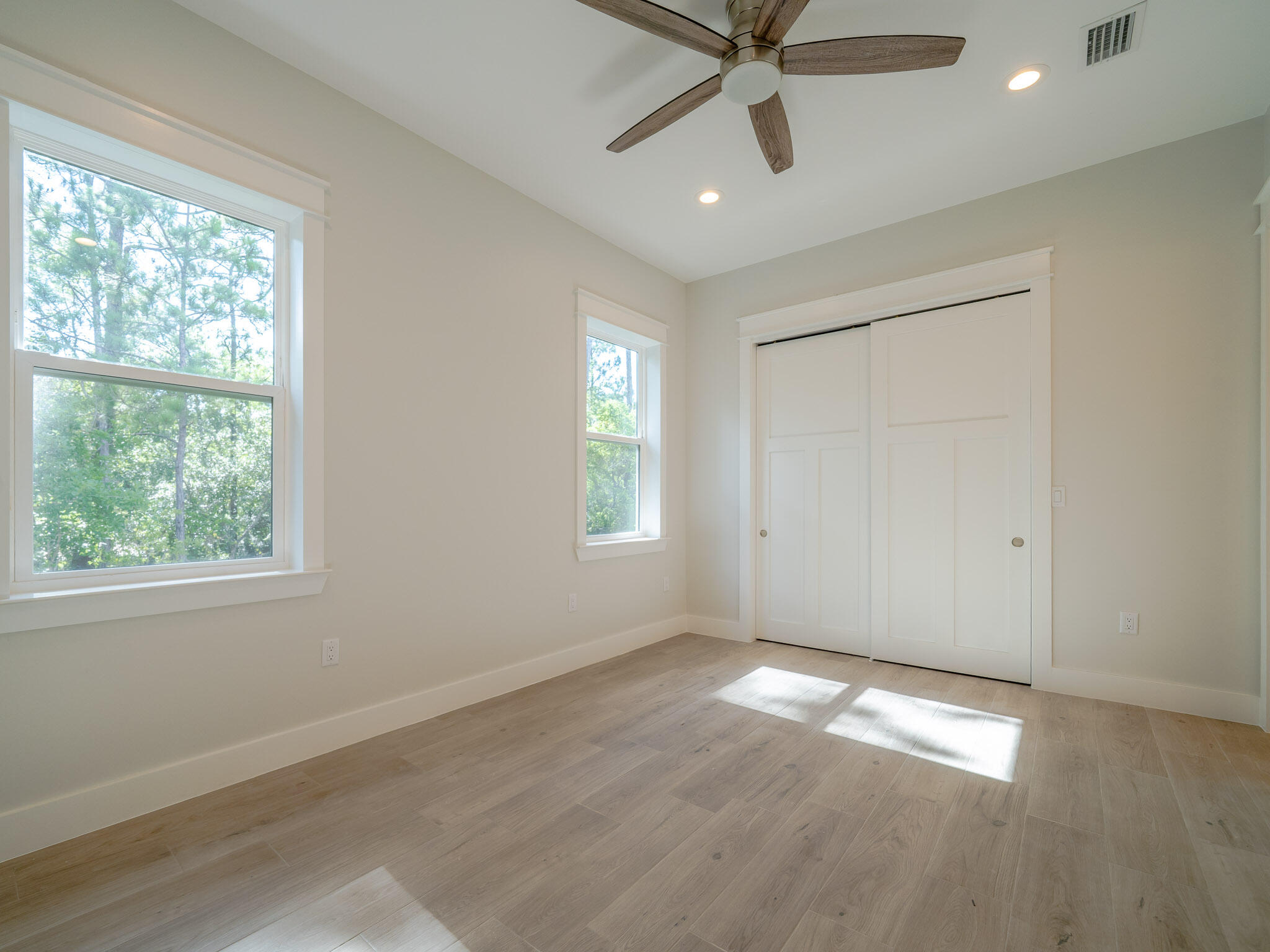 116 East Georgie Street Point Washington, FL 32459 - Photo 28 of 46 a view of empty room with wooden floor and fan