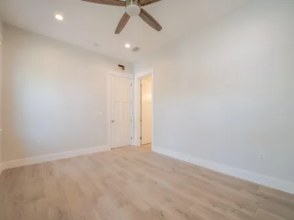 a view of an empty room with a ceiling fan