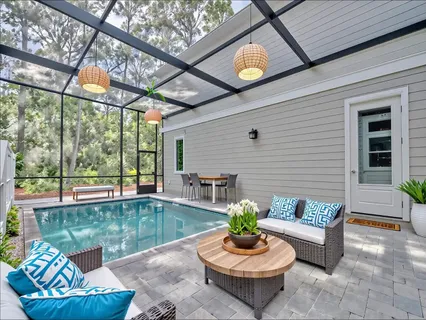 a view of a patio with a dining table and chairs with wooden floor and a fire pit