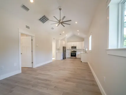 a kitchen with kitchen island a sink a stove a refrigerator and white cabinets