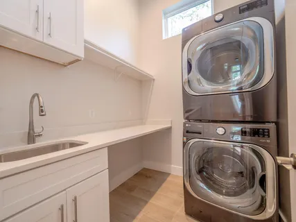 a bathroom with a granite countertop sink a mirror and shower
