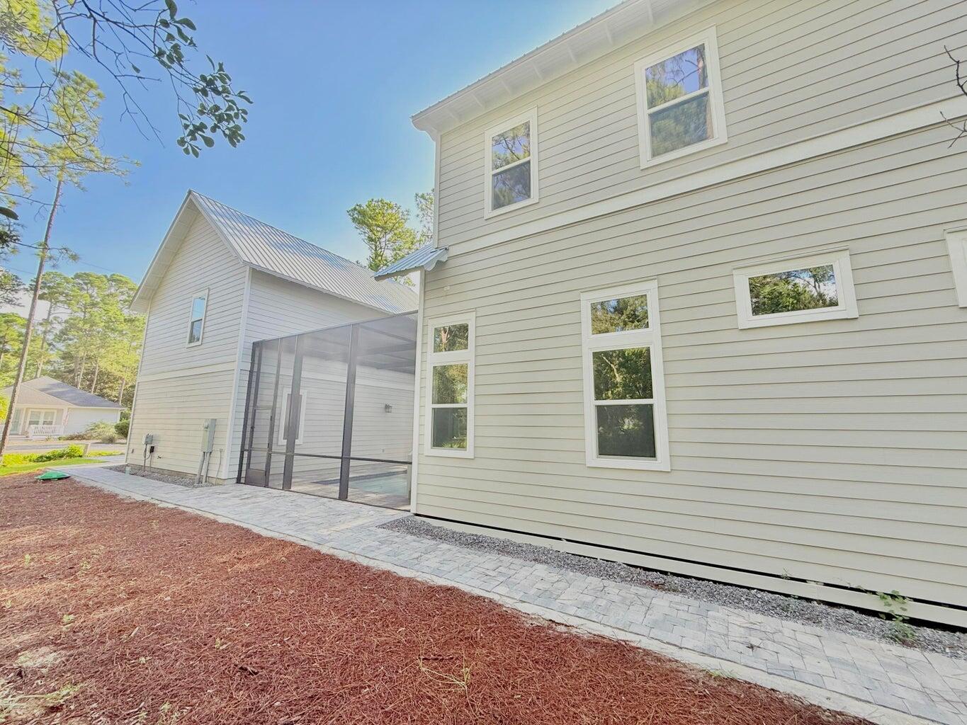 116 East Georgie Street Point Washington, FL 32459 - Photo 43 of 46 a view of a house with a backyard and a garage