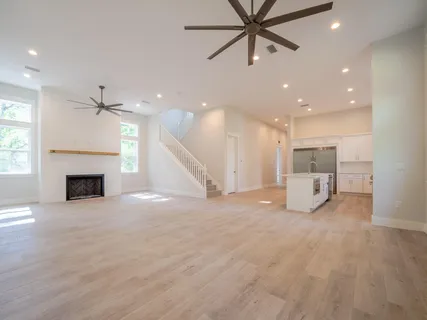 a view of an empty room with a fireplace and a window