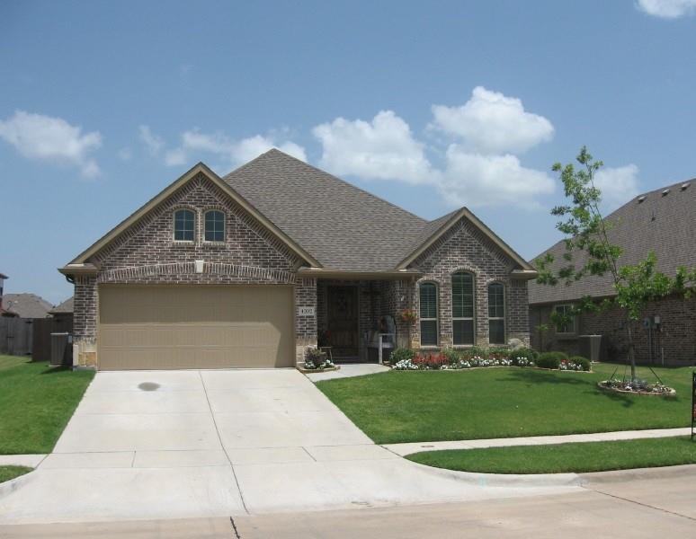 4302 Spruce Road Melissa, TX 75454 - Photo 2 of 15 a front view of a house with a yard and garage
