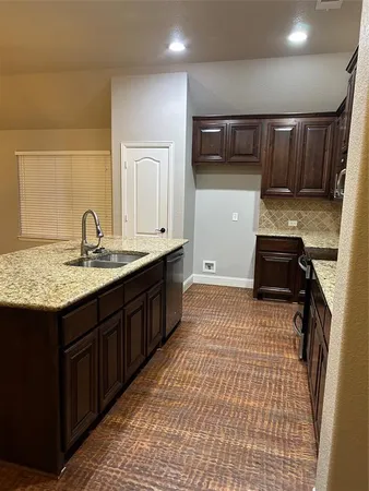 a kitchen with a sink and cabinets