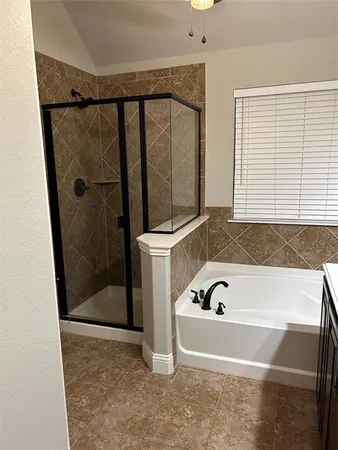 a bathroom with a bathtub and a shower