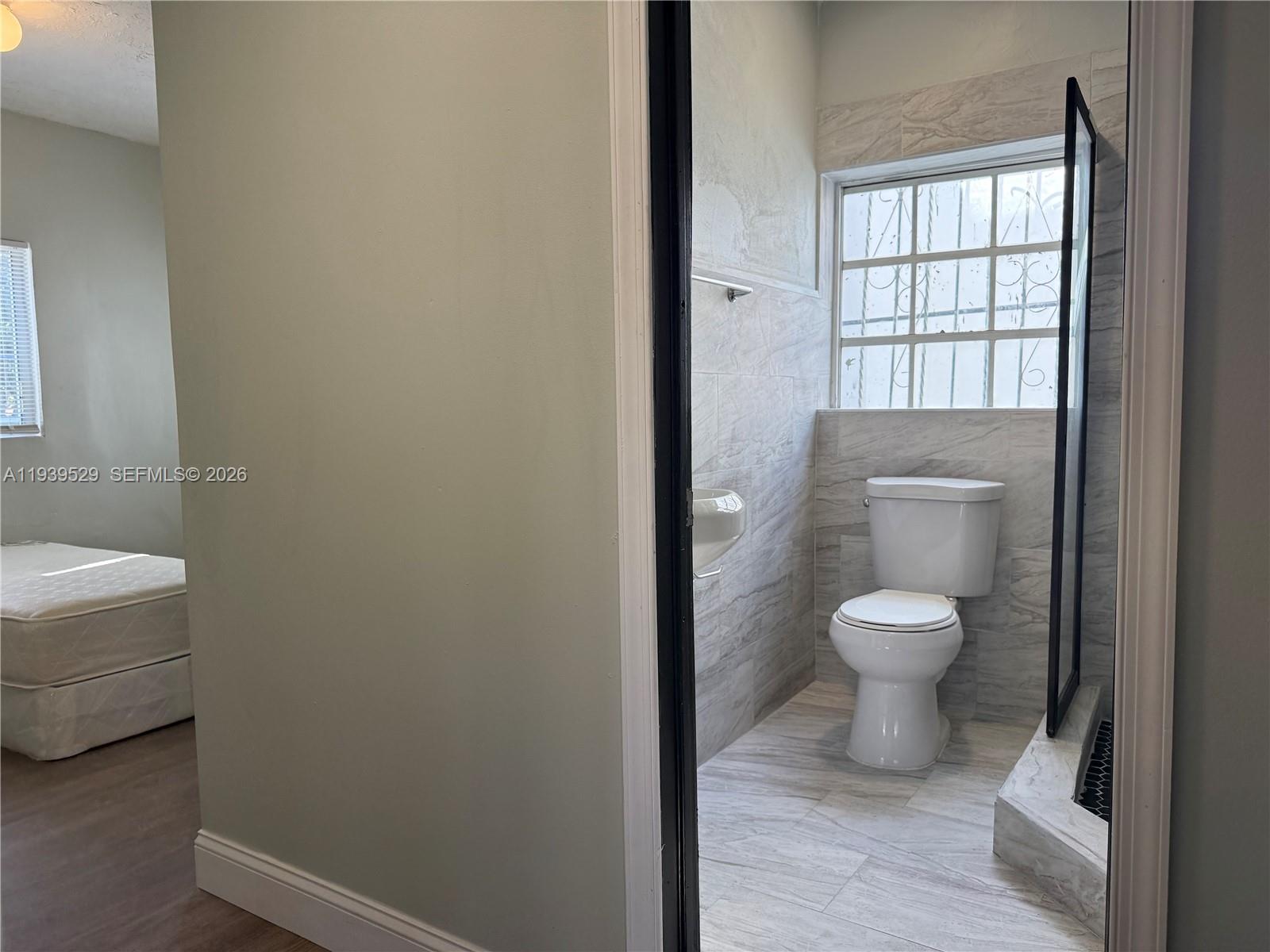 22 Northeast 51st Street, Unit 2 Miami, FL 33137 - Photo 13 of 14 a bathroom with a toilet