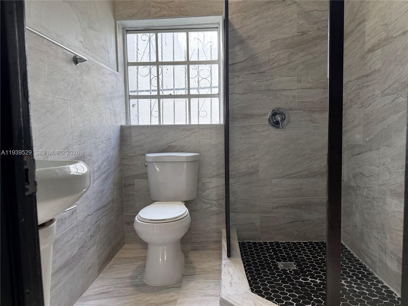 22 Northeast 51st Street, Unit 2 Miami, FL 33137 - Photo 14 of 14 a bathroom with a toilet and a sink