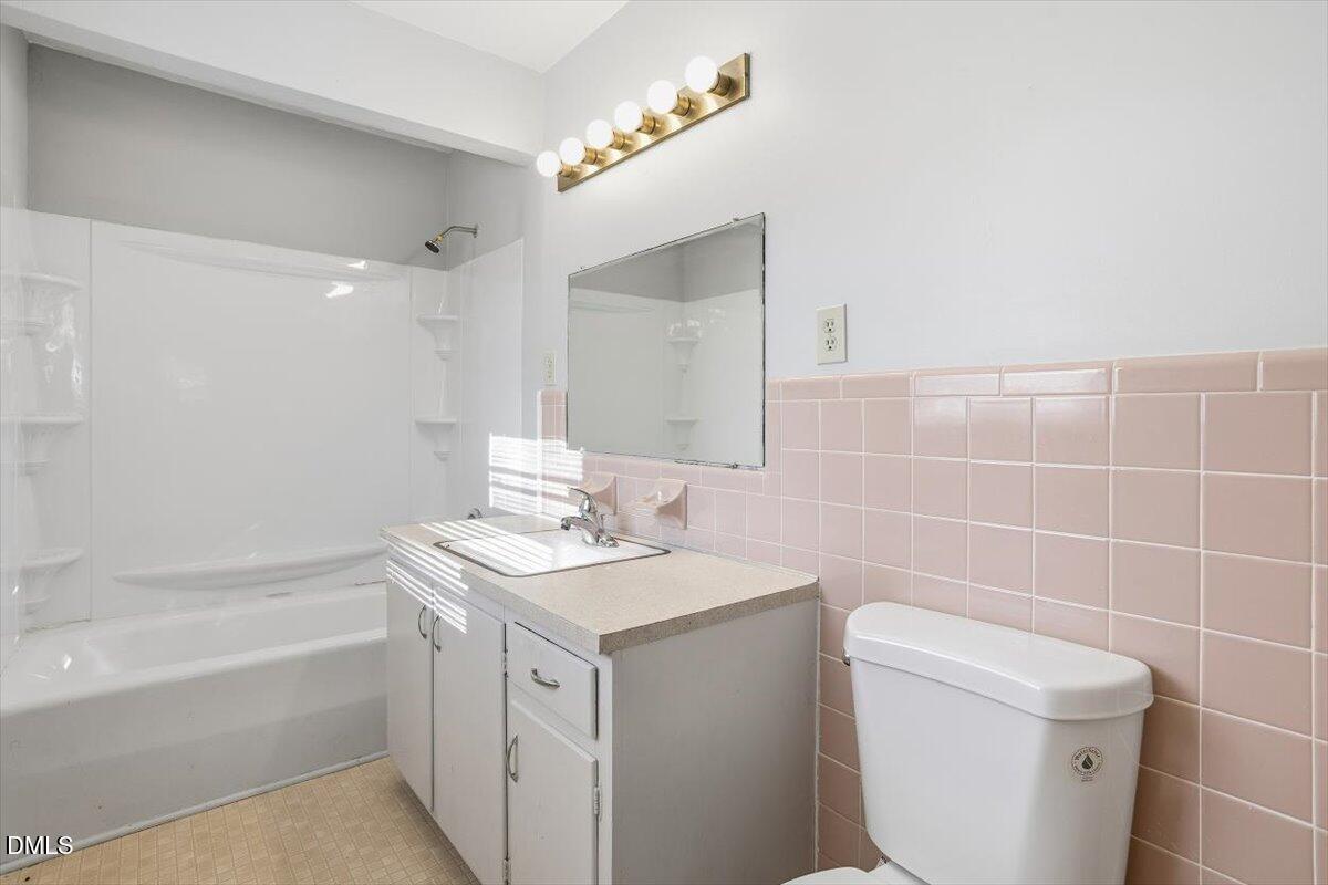 511 Hunter Street Durham, NC 27712 - Photo 20 of 31 a bathroom with a sink a toilet and a mirror