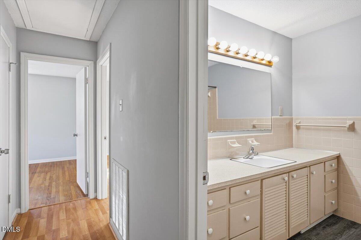 511 Hunter Street Durham, NC 27712 - Photo 23 of 31 a bathroom with a sink vanity and a mirror