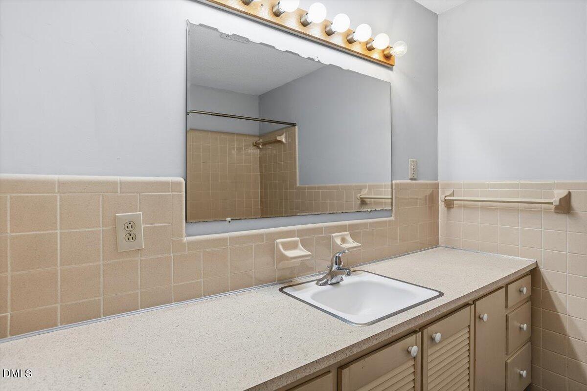 511 Hunter Street Durham, NC 27712 - Photo 24 of 31 a bathroom with a sink and a mirror