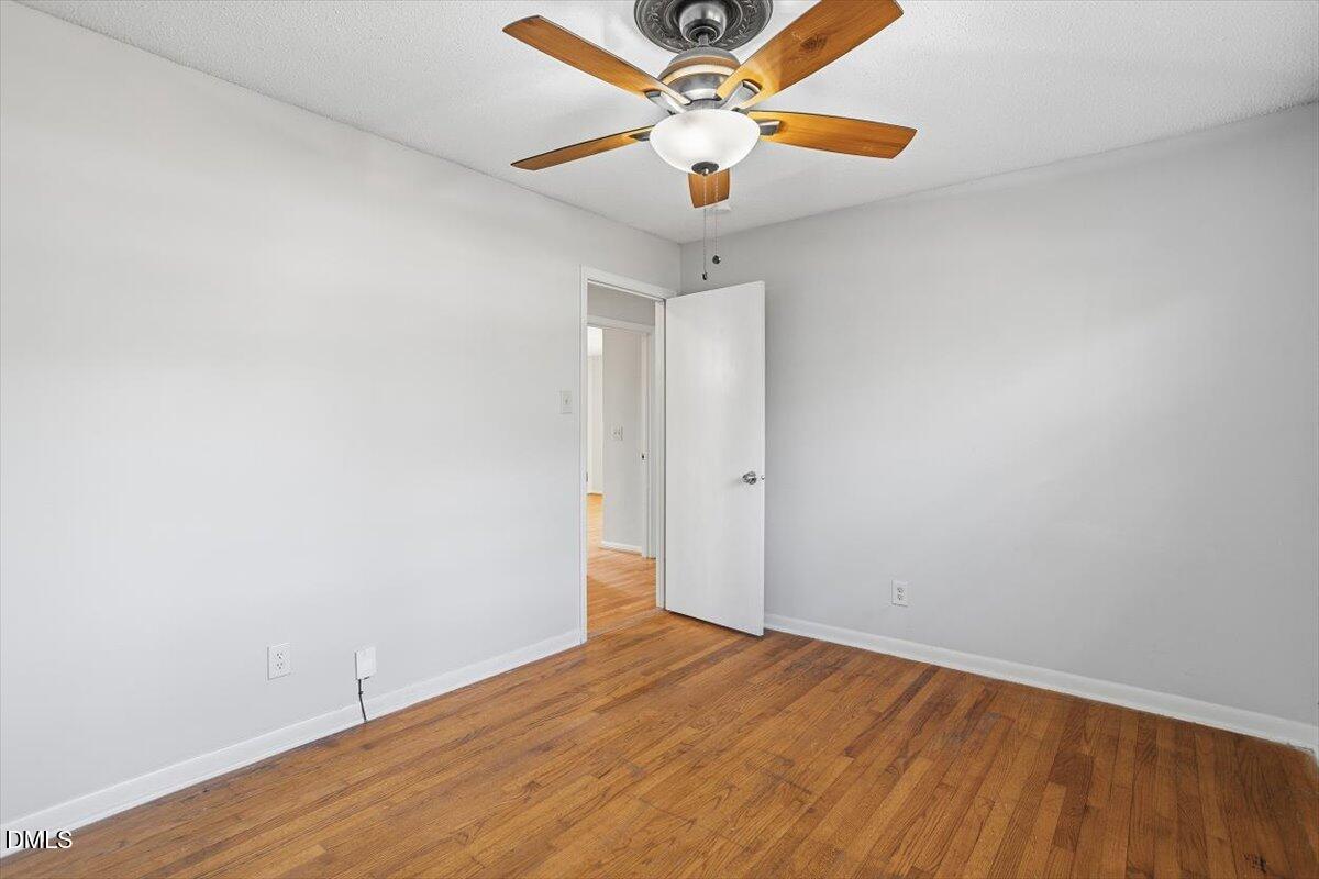 511 Hunter Street Durham, NC 27712 - Photo 26 of 31 an empty room with wooden floor and windows