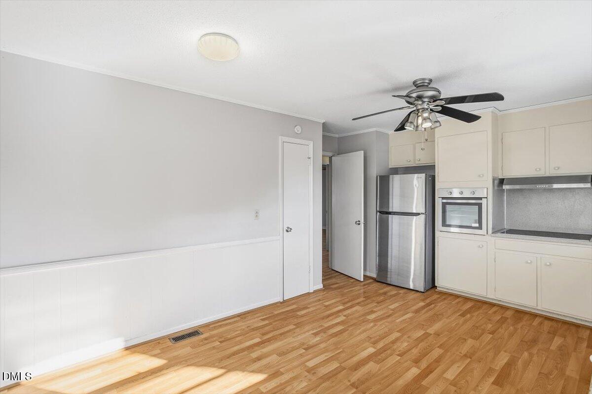 511 Hunter Street Durham, NC 27712 - Photo 10 of 31 a view of a kitchen with a sink and a refrigerator