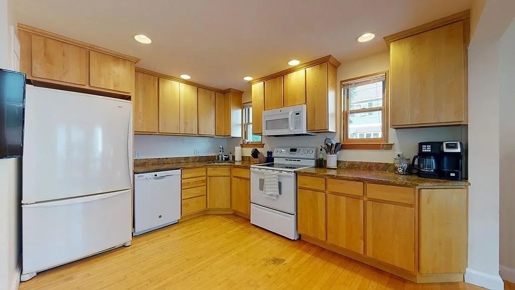 22 North Mead Street Boston, MA 02129 - Photo 6 of 7 a kitchen with stainless steel appliances granite countertop a refrigerator a stove a sink dishwasher and a refrigerator