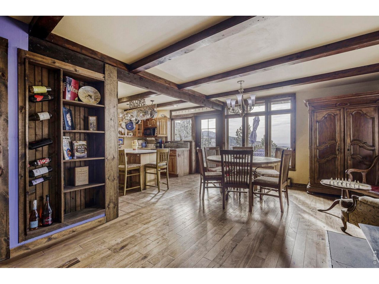 1042 Steamboat Valley Road Lyons, CO 80540 - Photo 15 of 46 East Wing- Dining Room. Beautiful wood floors. Beamed ceiling. French doors leading to outdoor patio concrete decks