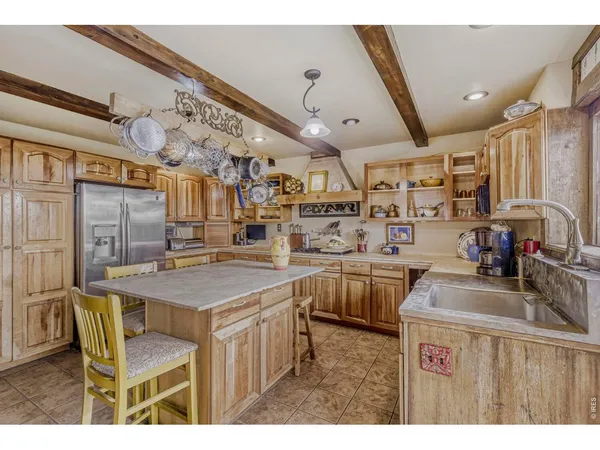 a kitchen that has a lot of cabinets in it and wooden cabinets