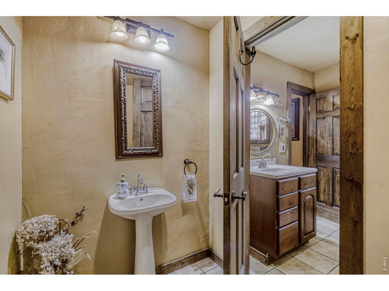 1042 Steamboat Valley Road Lyons, CO 80540 - Photo 21 of 46 East Wing - Main Floor powder room and shower, connected to bedroom #2 with LARGE storage closet