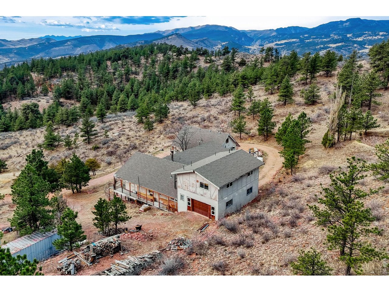 1042 Steamboat Valley Road Lyons, CO 80540 - Photo 3 of 46 Due South exposure from the front concrete patio deck, creating a natural rock warming, snow melting 1 mile long driveway. 1200 acres wildlife reserve to its right. Behind the home, 80 more acres of private land.