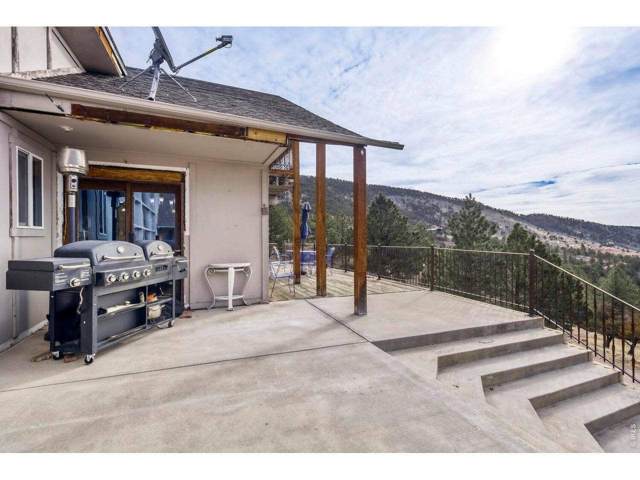 1042 Steamboat Valley Road Lyons, CO 80540 - Photo 31 of 46 NEW Reinforced concrete deck off front of home offering panoramic views of Pikes Peak. WIDE stairways leading to flat area parking.